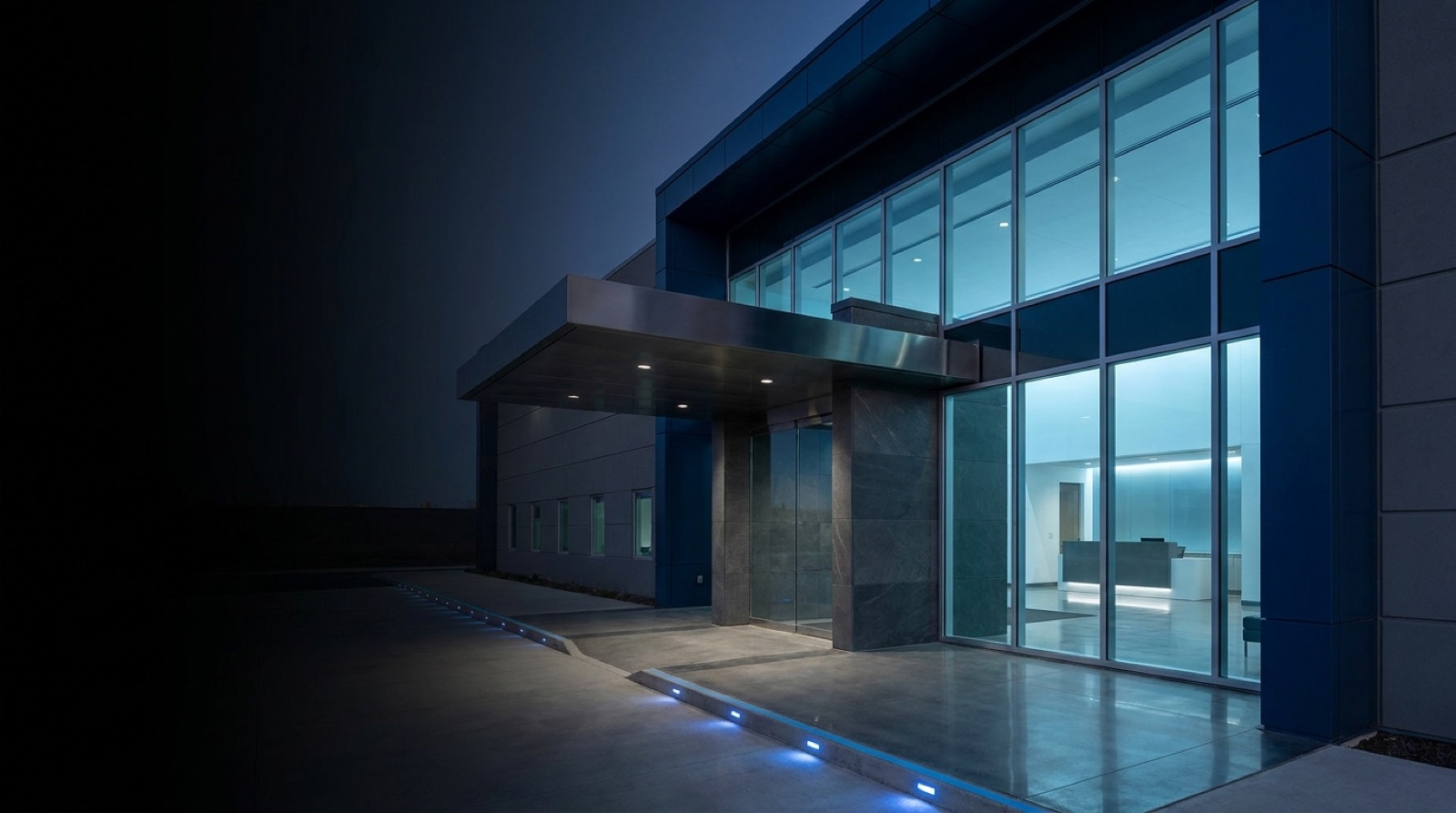 Entrance to a modern secure technology facility at dusk